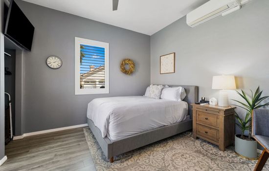 Calm, cozy bedroom w/ plush bedding & soft tones for restful nights.