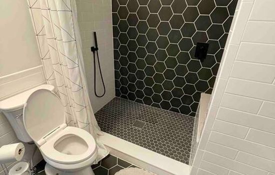 Extra large shower with rain shower head and spray wand