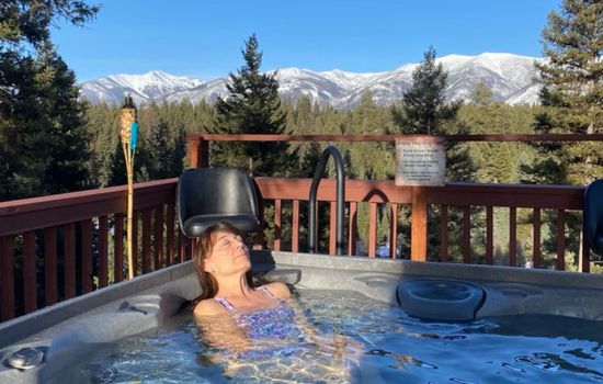 Relax and enjoy the hot tub after a day of adventure with a breathtaking view of the Swan mountains.
