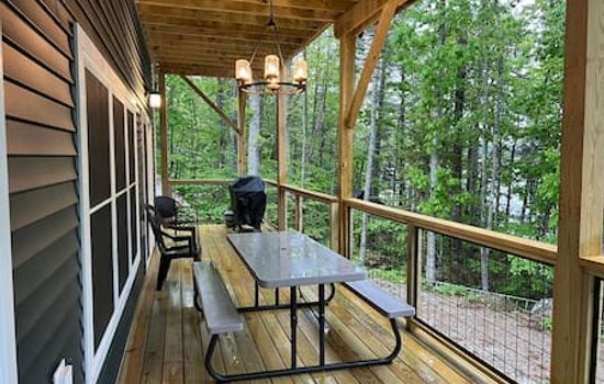 Deck with picnic table and grill.
