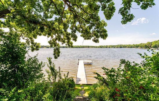 Summertime view from backyard to Bohner's lake.  Yes, we offer a sandy bottom lakefloor with access to private pier.