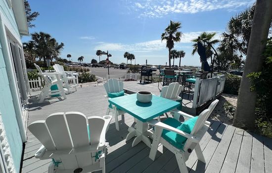 Large front deck with the beach across the street
