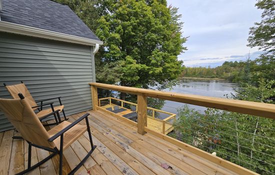 - Peaceful deck with rocking chairs and lake scenery   - Cozy spot for morning coffee and quiet outdoor time   - Relax above the water surrounded by nature views