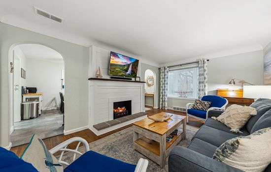 Large smart TV with electric fireplace insert