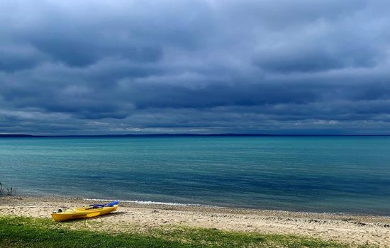 Private sandy beach with glowing blue waters