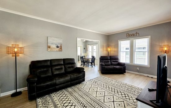 Spacious Living room with comfortable reclining couches and a 60" Smart TV with high speed internet