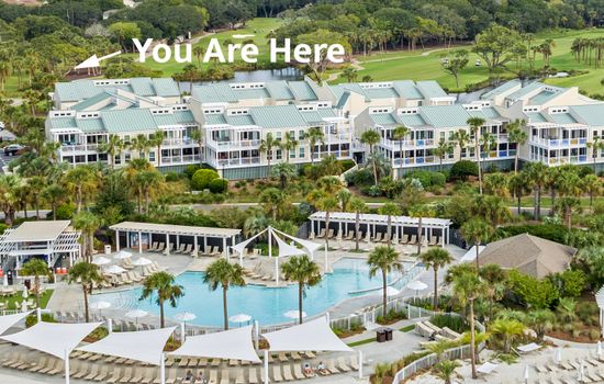 Sparkling outdoor pool surrounded by tropical greenery.