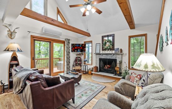 Living room with wood burning fireplace, TV and comfortable seating
