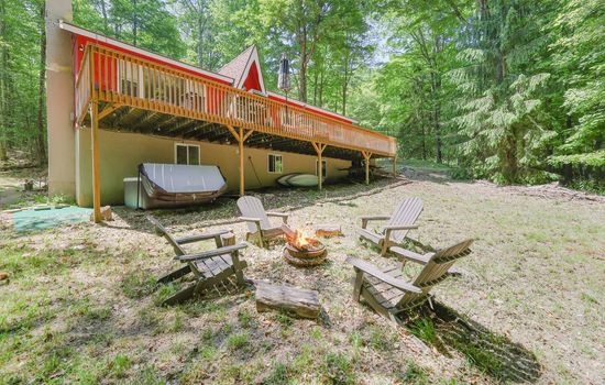 Backyard with firepit and hot tub - Serhii Vacation Rentals | Arrowhead Lake