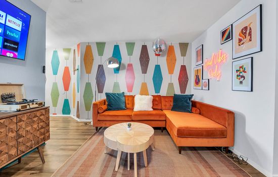 Groovy vibes and far-out charm in this retro-inspired living room - where neon signs and funky patterns take center stage!