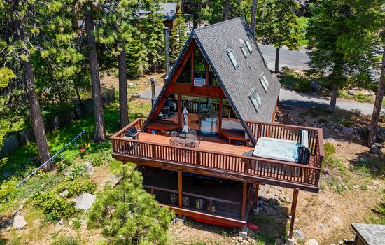 Soak up the sun from the back deck! Enjoy the private hot tub, patio table and BBQ grill. Plus there is a ping pong table underneath the deck.