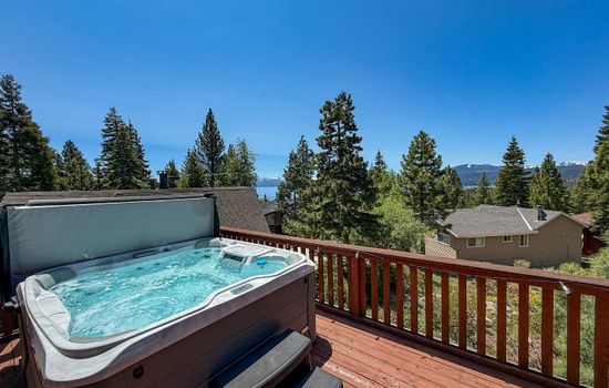Soak up the sun from the back deck! Enjoy the private hot tub, patio table and BBQ grill. Plus there is a ping pong table underneath the deck.