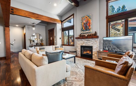 Relax in the inviting great room, where soaring ceilings and large windows flood the space with natural light. Cozy up by the stone fireplace and enjoy the 55" Smart TV.