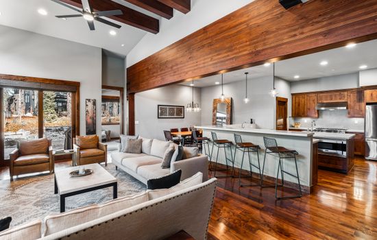 Relax in the inviting great room, where soaring ceilings and large windows flood the space with natural light. Cozy up by the stone fireplace and enjoy the 55" Smart TV.