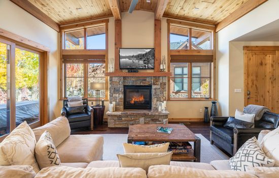 Relax in the inviting great room, where soaring ceilings and large windows flood the space with natural light while framing the picturesque mountain scenery. Cozy up by the stone fireplace and enjoy the 50" TV.