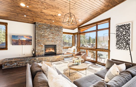 Relax in the inviting great room, where soaring ceilings and large windows flood the space with natural light while framing the picturesque mountain scenery. Cozy up by the stone fireplace and enjoy the 50" Smart TV.