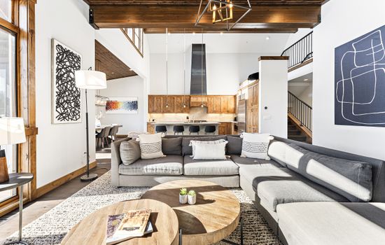 Relax in the inviting great room, where soaring ceilings and large windows flood the space with natural light while framing the picturesque mountain scenery. Cozy up by the stone fireplace and enjoy the 50" Smart TV.