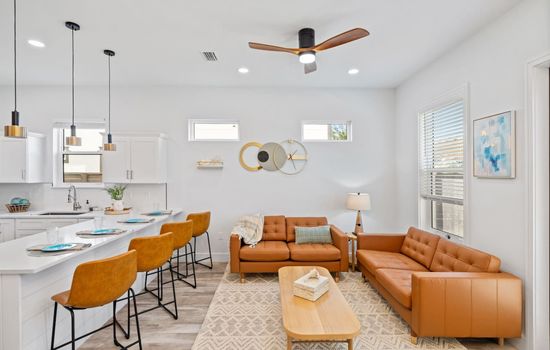 The living room is located just off the kitchen and next to the patio and backyard