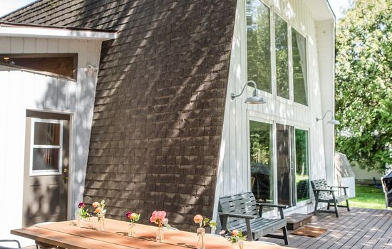 Enjoy dinners al fresco on this hand made farm table and large deck overlooking the lake surrounded by trees.