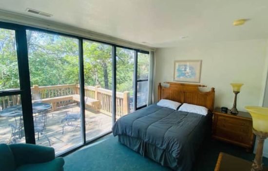 Let the forest be your backdrop—cozy up in this serene and naturally lit bedroom retreat.