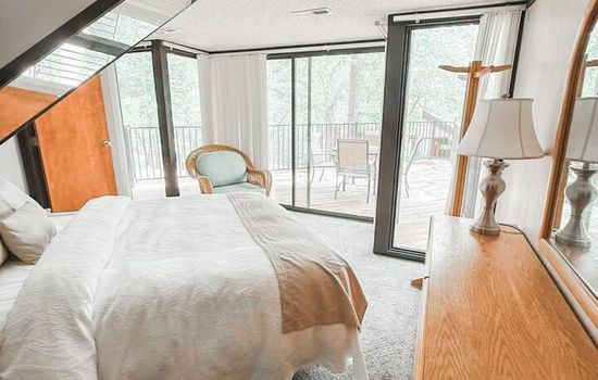 Inviting room with direct deck access, perfect for spontaneous nighttime lounging under the stars with friends and family.