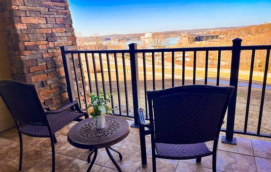 Enjoy peaceful lake views from your private balcony with comfortable seating.