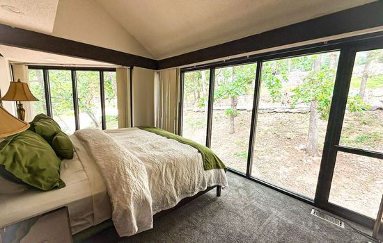 Wake up surrounded by treetops—this bedroom offers serene views and forest calm.