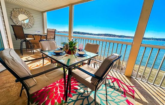 A stylish and comfortable outdoor dining space with panoramic views of the lake and marina.