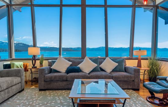 Enjoy panoramic Lake Tahoe views from the living room with floor-to-ceiling windows. Listen to the waves crash on the rocks below as you relax by the gas fireplace or watch your favorite shows on the smart TV.