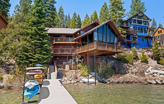 View of the house from the private pier with paddle boards and kayaks available for your use
