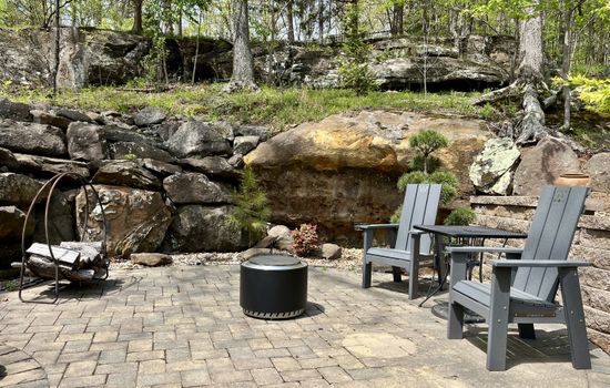 Smokeless firepit surrounded by natural rock and landscape