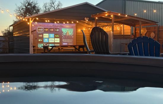 Evenings at The Game Barn - soak, stream, and unwind with movie nights on our 17-ft screen.