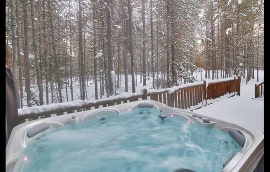 Relax in the outdoor hot tub while enjoying breathtaking views.