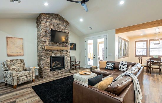 With its soaring brick fireplace and open floor plan, this living room feels both grand and grounded—a perfect blend of light, warmth, and comfort.