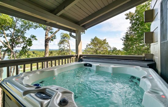 Relax in the private hot tub with panoramic Douglas Lake views