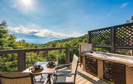 This inviting outdoor space offers the ideal setting to share meals or unwind while soaking in fresh mountain air and picturesque scenery.