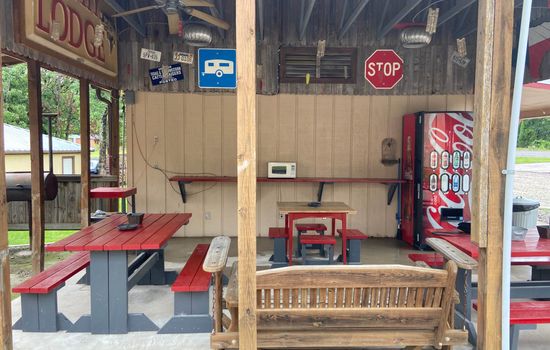 outdoor seating area with BBQ grill and beverage machine