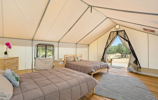 Two comfortable queen beds inside with a propane heater in your tent