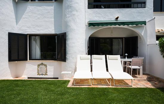 Private garden at the back of the property with 3 sun loungers and a full dining set 