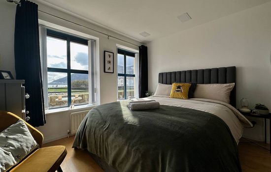 King bed with Mourne mountain and sea views