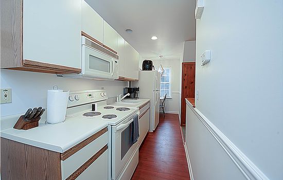 Galley Kitchen with Stove, Oven, Microwave, Sink, and Refrigerator