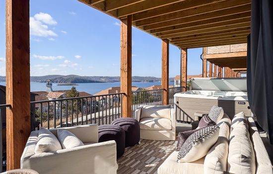 Seating and hot tub on deck to lounge and relax