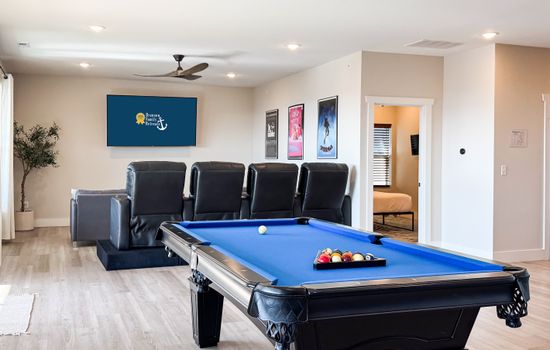 Theater and game room with access to 2nd level deck