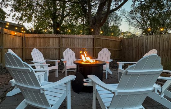 Propane fire pit with ample seating. Private and spacious fully fenced in yard at the Bank Haus