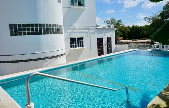 crystal clear infinity  pool with overwater deck