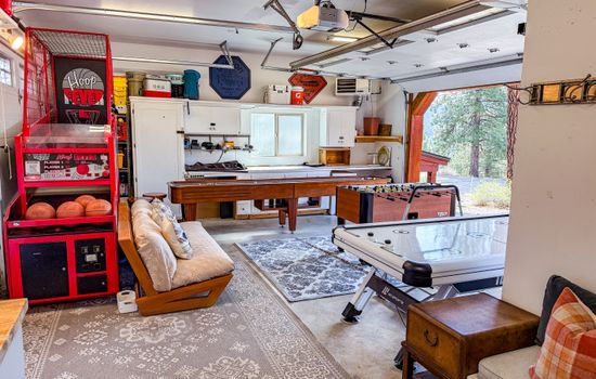 The garage has been transformed into a fun-filled game room featuring Hoop Fever, shuffleboard, air hockey, and foosball. Plus, it's fully heated for year-round enjoyment. In the summer, open up the garage and enjoy the fresh air!