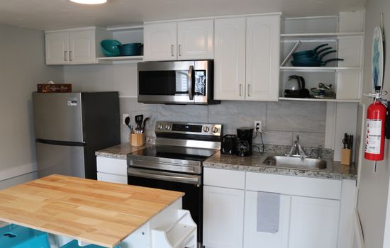 a fully stocked kitchen awaits complete with an island with seating for 2 and all the essentials.