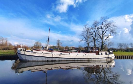 "Vertrouwen" 'Trust' was built in Harlingen, Netherlands in 1913 as a commercial sailing ship, carrying 'turf' (Peat), bricks, potatoes and anything that was required.  She had one huge mast and possibly a smaller steadying sail at the stern. 