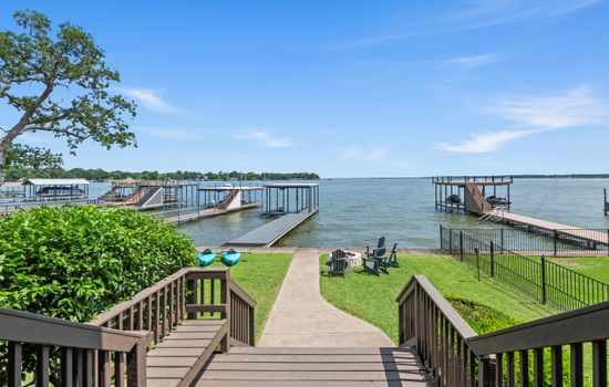 From the back porch, savor uninterrupted views of open water and your private dock—where luxury meets lakeside living.