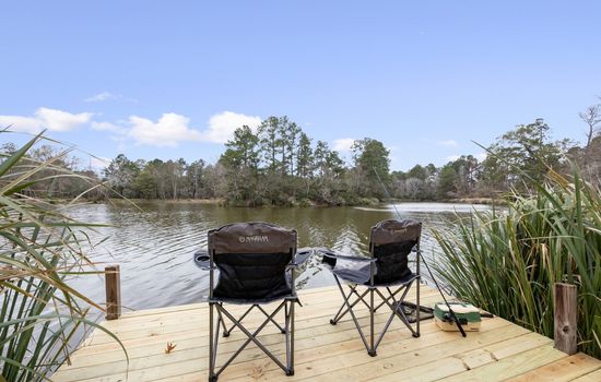 Two lakeside chairs on a private dock, offering a calm spot to relax, fish, and take in the peaceful view
